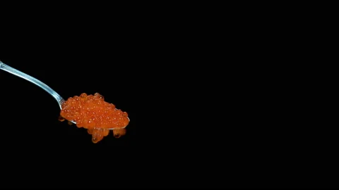 Red caviar drops from a spoon in 4K Vídeo Stock 136567362