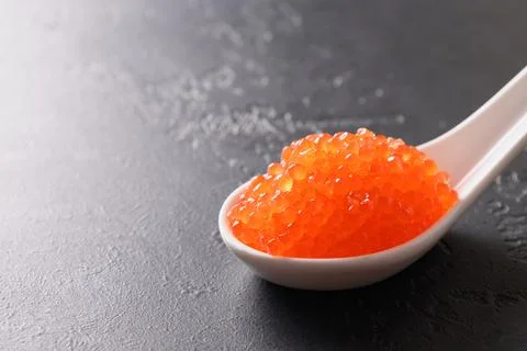 Red caviar on ice cube. Stock Photos