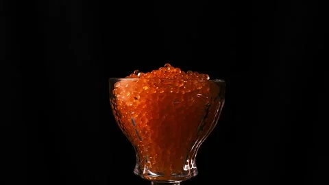 Red caviar. isolated on black background close-up slow motion rotating Stock Footage 257088587