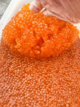 Red caviar in plastic container. Salmon caviar, diet food. Stock Photos