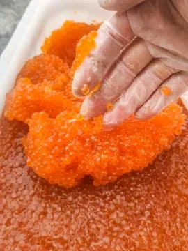 Red caviar in plastic container. Salmon caviar, diet food. Stock Photos