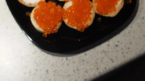 Red caviar is put with a spoon on tartlets with cottage cheese. Preparation of 스톡 동영상 119403806