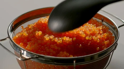 Red Caviar scoop up spoon. Close-up salmon caviar rotation. Trout Delicatessen. Stock Footage 113973839