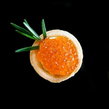 Red caviar in the shape of a fruit Stock Photos