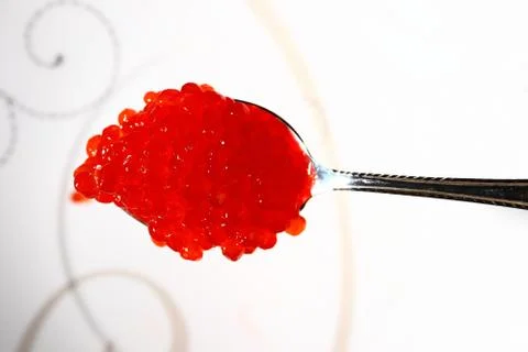 Red caviar in the silver spoon. Macro. Stock Photos