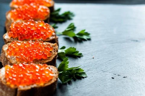 Red caviar on slate background Foto stock
