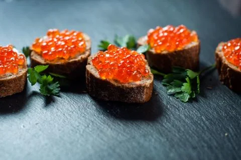 Red caviar on slate background Stock Photos