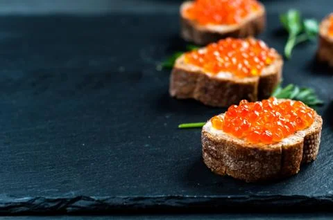 Red caviar on slate background 库存照片