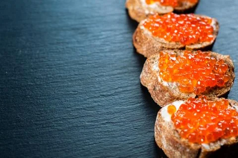 Red caviar on slate background Stock Photos