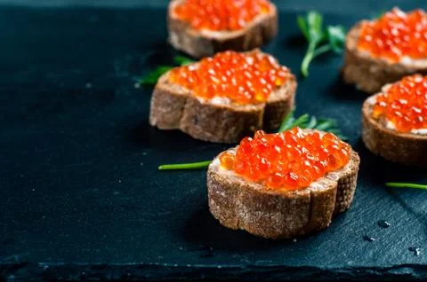 Red caviar on slate background. Stock-Fotos
