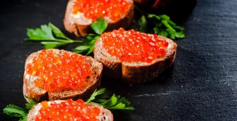 Red caviar on slate background. Fotos de archivo