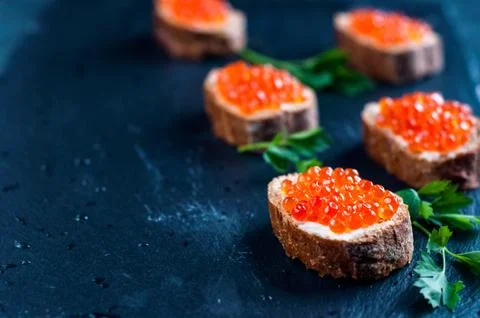 Red caviar on slate background. Stock-Fotos
