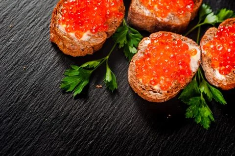 Red caviar on slate background. 库存照片