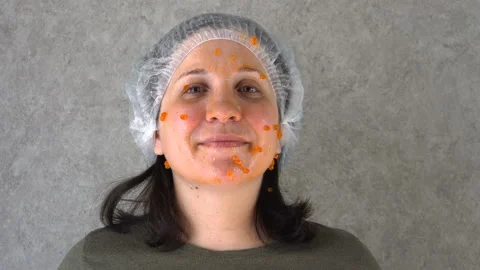 Red caviar is smeared on a woman's face 4K Video stock 127597893