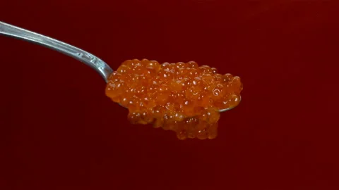 Red caviar in a spoon falls Stock Footage 137226981