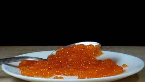 Red caviar with a spoon on a plate. Stock Footage 136470417