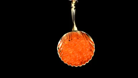Red Caviar in a spoon rotating over black background. Closeup of salmon fish roe Stock Footage 314160671