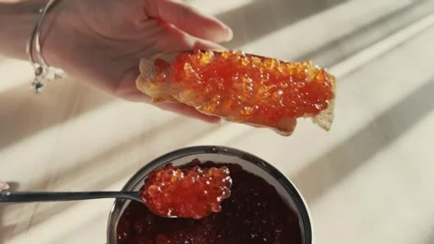 Red caviar spread on bread Stock Footage 254608792