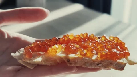 Red caviar spread on bread Stock Footage 254609197