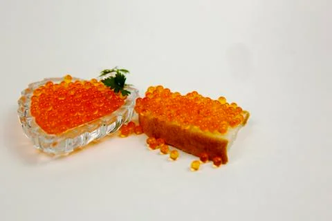 Red caviar spreading bread on a white background Stock Photos