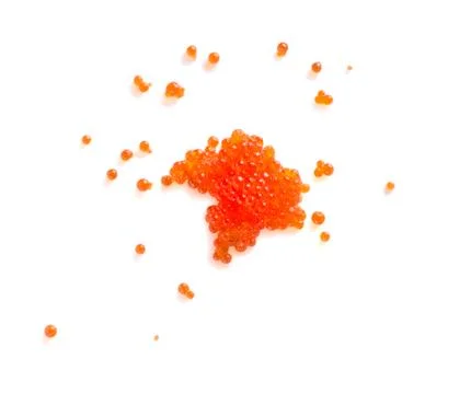 Red caviar on white background. Small round caviar are scattered on the surfa Stock Photos