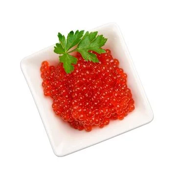 Red caviar in a white square ceramic bowl decorated with a sprig of parsley Stock Photos