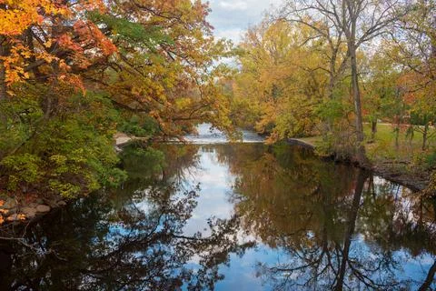 Red Cedar river winding through Michigan State University campus during the Fall Stock Photos