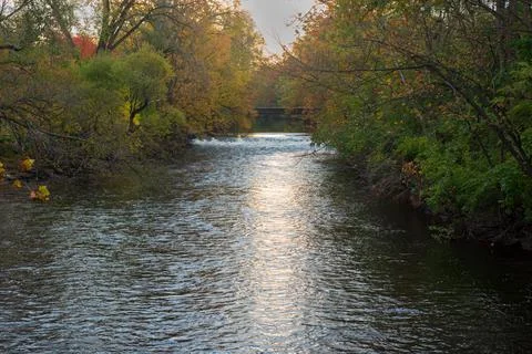 Red Cedar river winding through Michigan State University campus during the Fall Stock Photos