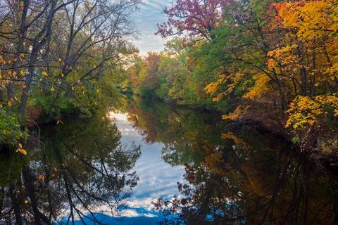 Red Cedar river winding through Michigan State University campus during the Fall 写真素材