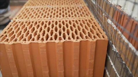 Red ceramic block for the construction of a private house.. A stack of red da Stock Photos