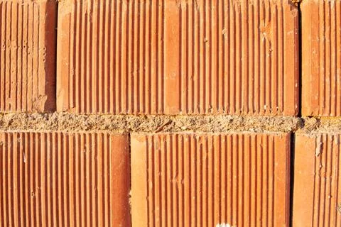 Red ceramic bricks close up. Keramoblock. Red brick wall texture background. Stock Photos