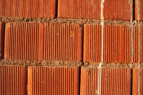 Red ceramic bricks close up. Keramoblock. Red brick wall texture background. Stock Photos