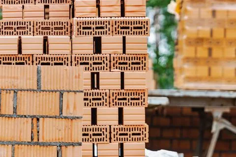 Red ceramic bricks at the construction site. Keramoblock. Hollow brick. Const Stock Photos