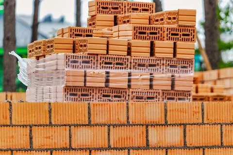 Red ceramic bricks at the construction site. Keramoblock. Hollow brick. Const Stock Photos