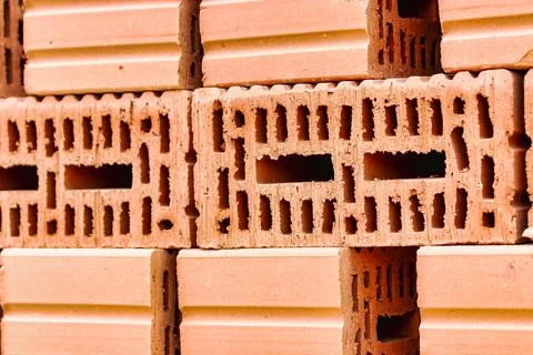 Red ceramic bricks at the construction site. Keramoblock. Hollow brick. Const Stock Photos