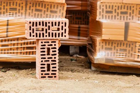 Red ceramic bricks at the construction site. Keramoblock. Hollow brick. Const Stock Photos
