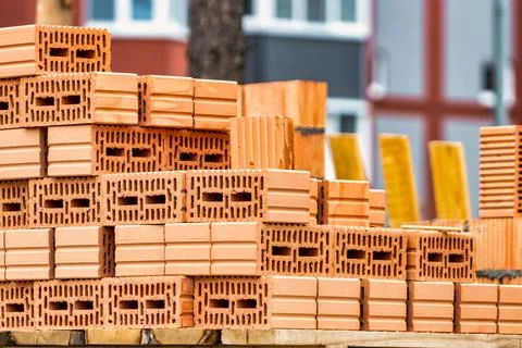 Red ceramic bricks at the construction site. Keramoblock. Hollow brick. Const Stock Photos