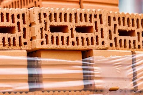 Red ceramic bricks at the construction site. Keramoblock. Hollow brick. Const Stock Photos
