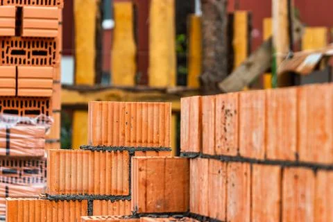 Red ceramic bricks at the construction site. Keramoblock. Hollow brick. Const Stock Photos