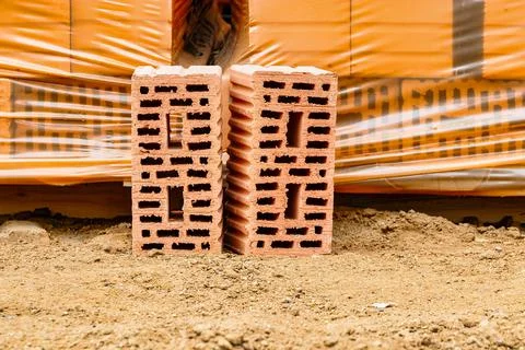 Red ceramic bricks at the construction site. Keramoblock. Hollow brick. Const Stock Photos