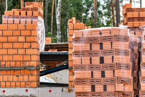 Red ceramic bricks at the construction site. Keramoblock. Hollow brick. Const Stock Photos