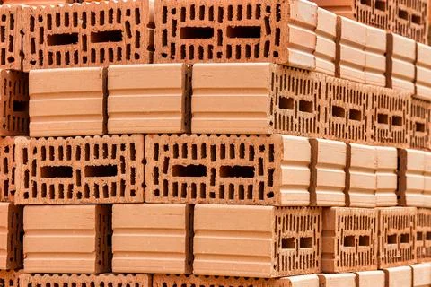 Red ceramic bricks at the construction site. Keramoblock. Hollow brick. Const Stock Photos