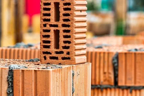 Red ceramic bricks at the construction site. Keramoblock. Hollow brick. Const 写真素材