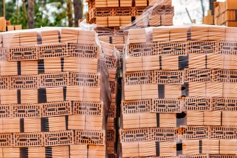 Red ceramic bricks at the construction site. Keramoblock. Hollow brick. Const Stock Photos