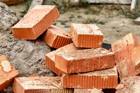 Red ceramic bricks at the construction site. Keramoblock. Hollow brick. Const Stock Photos