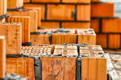 Red ceramic bricks at the construction site. Keramoblock. Hollow brick. Const Stock Photos