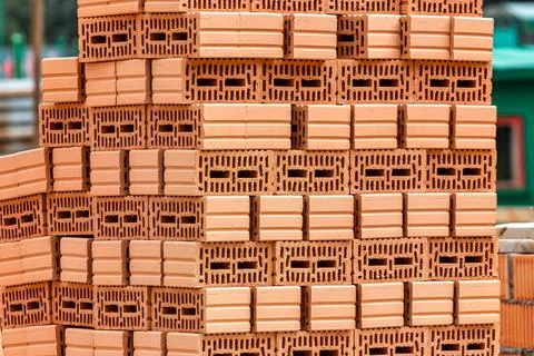 Red ceramic bricks at the construction site. Keramoblock. Hollow brick. Const Stock Photos