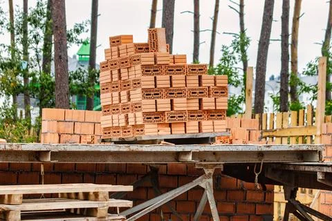 Red ceramic bricks at the construction site. Keramoblock. Hollow brick. Const Stock Photos