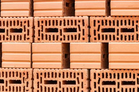 Red ceramic bricks at the construction site. Keramoblock. Hollow brick. Const Stock Photos