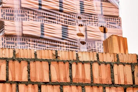 Red ceramic bricks at the construction site. Keramoblock. Hollow brick. Const 스톡 사진